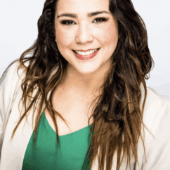 Laura Robert-Rivera smiling at the camera against a white background.